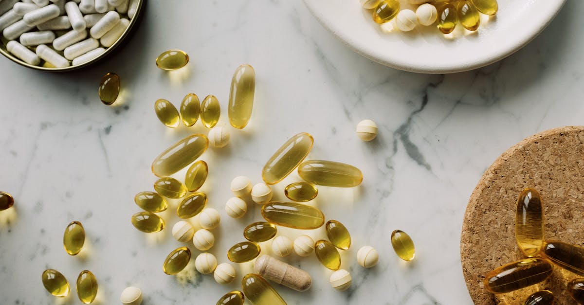 pexels-photo-3850790-3850790 A collection of supplements and pills scattered on a marble surface, showcasing healthcare essentials.
